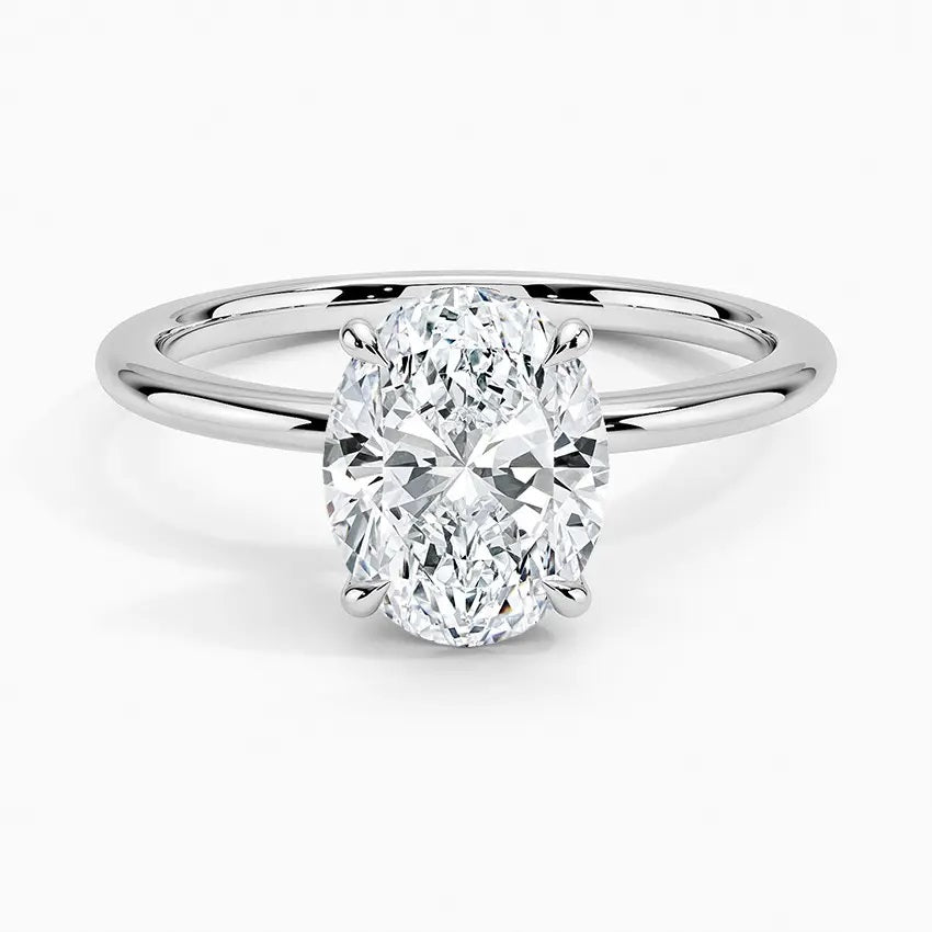 Oval cut Moissanite lab grown diamond engagement ring round shank with a four claw setting, on a gold band, against a white background.Moissanite engagement ring cape town south africa grand diamonds ralph jacobs jeuli