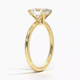 Oval cut Moissanite lab grown diamond engagement ring round shank with a four claw setting, on a gold band, against a white background.Moissanite engagement ring cape town south africa grand diamonds ralph jacobs jeuli