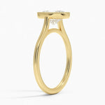 Oval shape Moissanite lab grown diamond engagement ring round shank with a bezel setting, on a gold band, against a white background.Moissanite engagement ring cape town south africa grand diamonds ralph jacobs jeulia 