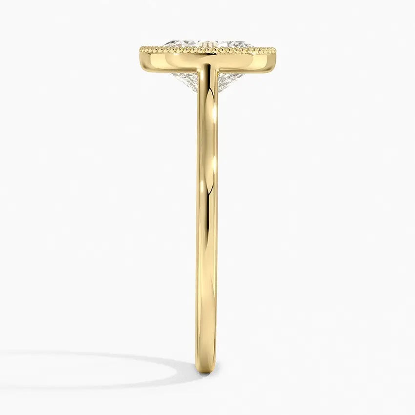 Oval shape Moissanite lab grown diamond engagement ring round shank with a bezel setting, on a gold band, against a white background.Moissanite engagement ring cape town south africa grand diamonds ralph jacobs jeulia 