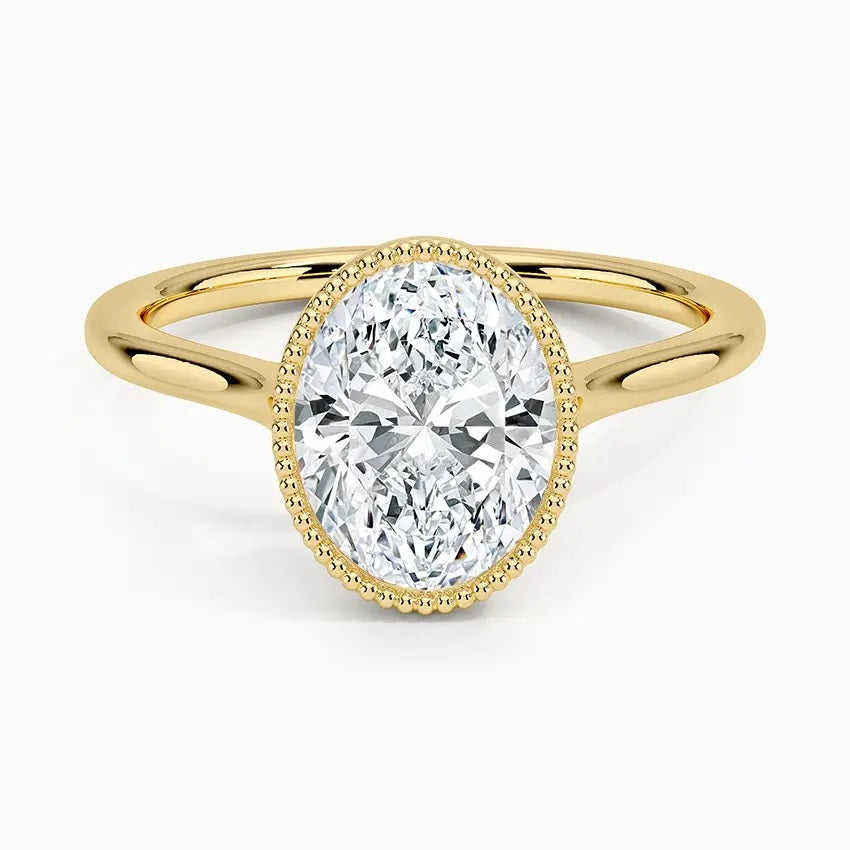 Oval shape Moissanite lab grown diamond engagement ring round shank with a bezel setting, on a gold band, against a white background.Moissanite engagement ring cape town south africa grand diamonds ralph jacobs jeulia 