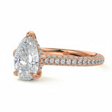 Pear cut Moissanite lab grown diamond engagement ring with three row micro pave set gold shank, hidden halo and moissanite encrusted claws against a white background.Moissanite engagement ring cape town south africa grand diamonds ralph jacobs jeulia 