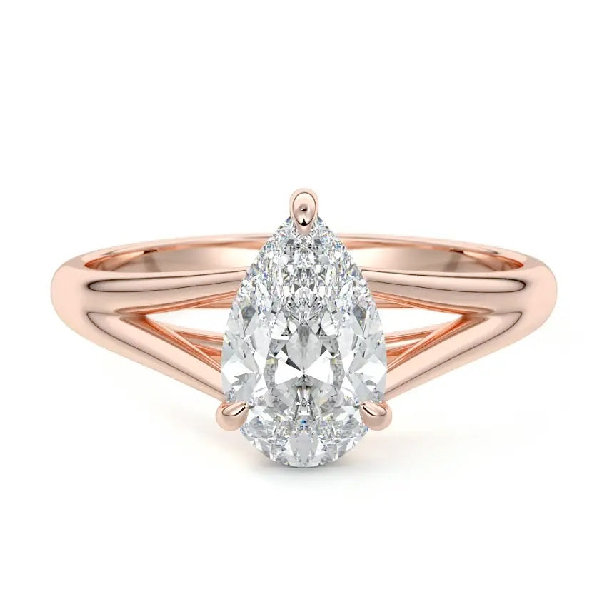 Pear cut Moissanite lab grown diamond engagement ring v-split band with a three claw cathedral setting, on a gold band, against a white background.Moissanite engagement ring cape town south africa grand diamonds ralph jacobs jeulia