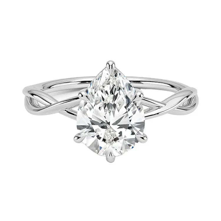 Pear cut Moissanite lab grown diamond engagement ring twisted shank with a six claw setting, on a gold band, against a white background.Moissanite engagement ring cape town south africa grand diamonds ralph jacobs jeulia  