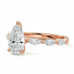 Pear cut Moissanite lab grown diamond engagement ring half eternity fancy set shank with classic three prong setting, on a gold band, against a white background.Moissanite engagement ring cape town south africa grand diamonds ralph jacobs jeulia 