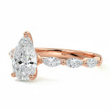 Pear cut Moissanite lab grown diamond engagement ring half eternity fancy set shank with classic three prong setting, on a gold band, against a white background.Moissanite engagement ring cape town south africa grand diamonds ralph jacobs jeulia 