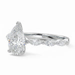 Pear cut Moissanite lab grown diamond engagement ring half eternity fancy set shank with classic three prong setting, on a gold band, against a white background.Moissanite engagement ring cape town south africa grand diamonds ralph jacobs jeulia 