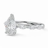 Pear cut Moissanite lab grown diamond engagement ring half eternity fancy set shank with classic three prong setting, on a gold band, against a white background.Moissanite engagement ring cape town south africa grand diamonds ralph jacobs jeulia 