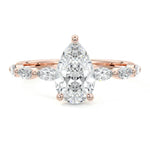 Pear cut Moissanite lab grown diamond engagement ring half eternity fancy set shank with classic three prong setting, on a gold band, against a white background.Moissanite engagement ring cape town south africa grand diamonds ralph jacobs jeulia 