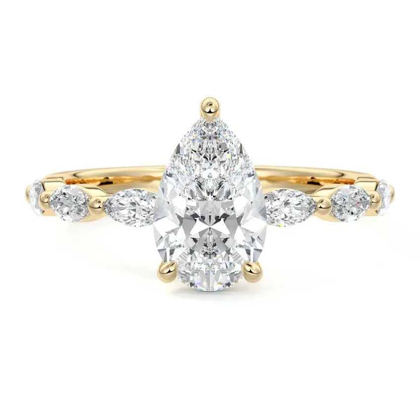 Pear cut Moissanite lab grown diamond engagement ring half eternity fancy set shank with classic three prong setting, on a gold band, against a white background.Moissanite engagement ring cape town south africa grand diamonds ralph jacobs jeulia 