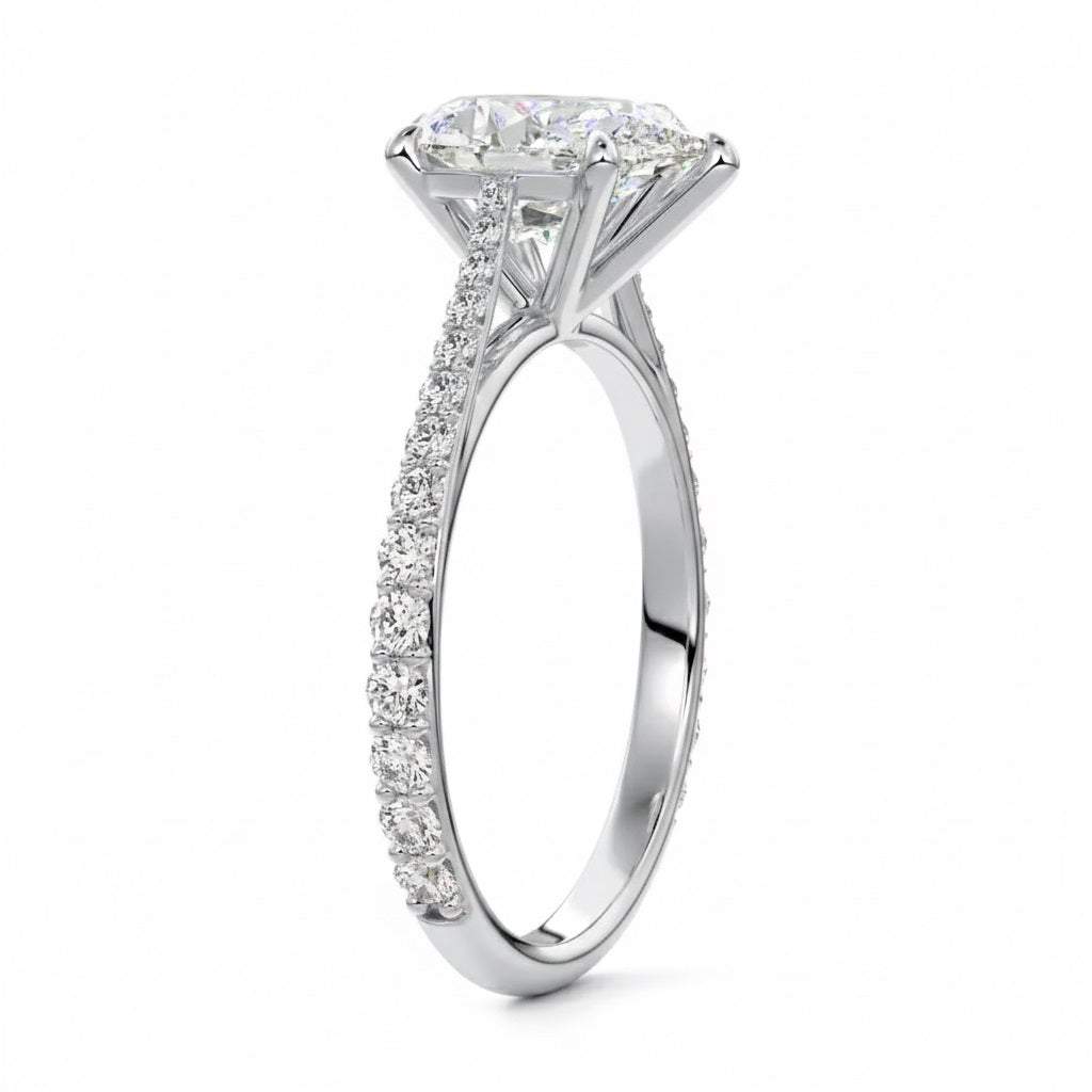 Pear cut Moissanite lab grown diamond engagement ring pave set shank with cathedral setting, on a gold band, against a white background.Moissanite engagement ring cape town south africa grand diamonds ralph jacobs jeulia 