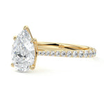 Pear cut Moissanite lab grown diamond engagement ring pave set shank with cathedral setting, on a gold band, against a white background.Moissanite engagement ring cape town south africa grand diamonds ralph jacobs jeulia 