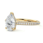 Pear cut Moissanite lab grown diamond engagement ring with three row micro pave set gold shank, hidden halo and moissanite encrusted claws against a white background.Moissanite engagement ring cape town south africa grand diamonds ralph jacobs jeulia 