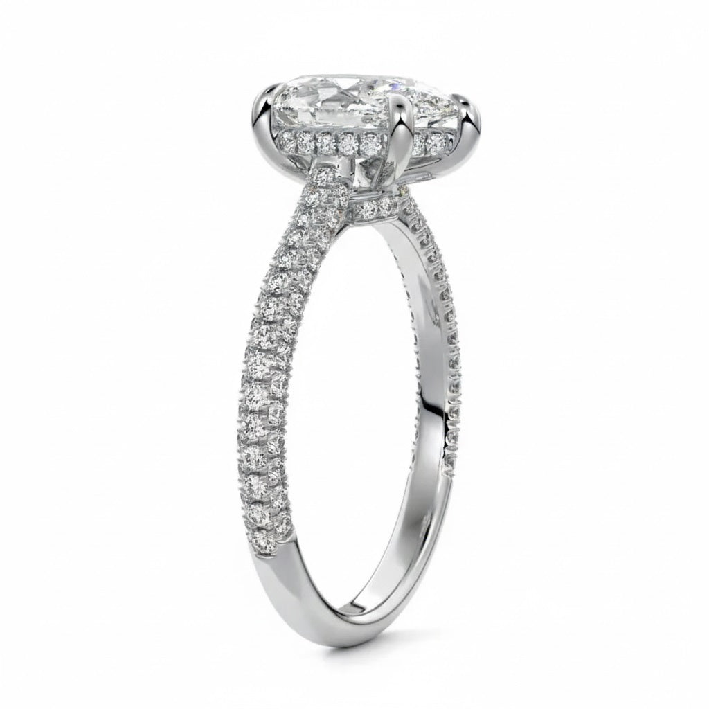 Pear cut Moissanite lab grown diamond engagement ring with three row micro pave set gold shank, hidden halo and moissanite encrusted claws against a white background.Moissanite engagement ring cape town south africa grand diamonds ralph jacobs jeulia 