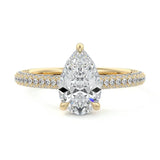 Pear cut Moissanite lab grown diamond engagement ring with three row micro pave set gold shank, hidden halo and moissanite encrusted claws against a white background.Moissanite engagement ring cape town south africa grand diamonds ralph jacobs jeulia 