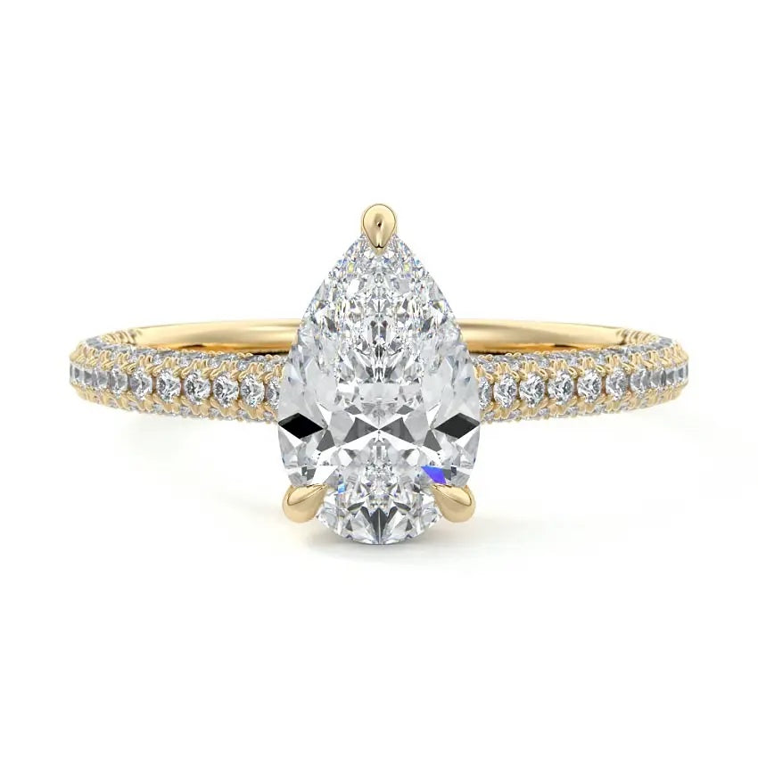 Pear cut Moissanite lab grown diamond engagement ring with three row micro pave set gold shank, hidden halo and moissanite encrusted claws against a white background.Moissanite engagement ring cape town south africa grand diamonds ralph jacobs jeulia 