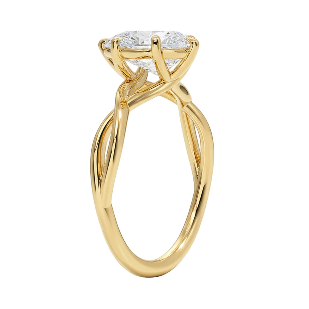Pear cut Moissanite lab grown diamond engagement ring twisted shank with a six claw setting, on a gold band, against a white background.Moissanite engagement ring cape town south africa grand diamonds ralph jacobs jeulia  