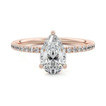 Pear cut Moissanite lab grown diamond engagement ring half eternity set shank with classic three prong setting, on a gold band, against a white background.Moissanite engagement ring cape town south africa grand diamonds ralph jacobs jeulia 