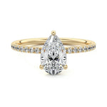 Pear cut Moissanite lab grown diamond engagement ring half eternity set shank with classic three prong setting, on a gold band, against a white background.Moissanite engagement ring cape town south africa grand diamonds ralph jacobs jeulia 