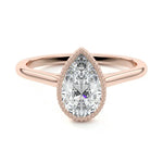 Pear shape Moissanite lab grown diamond engagement ring round shank with a bezel setting, on a gold band, against a white background.Moissanite engagement ring cape town south africa grand diamonds ralph jacobs jeulia 