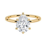 Pear cut Moissanite lab grown diamond engagement ring round shank with a six claw setting, on a gold band, against a white background.Moissanite engagement ring cape town south africa grand diamonds ralph jacobs jeuli