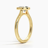 Pear shape Moissanite lab grown diamond engagement ring round shank with a bezel setting, on a gold band, against a white background.Moissanite engagement ring cape town south africa grand diamonds ralph jacobs jeulia 