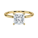 Princess cut Moissanite lab grown diamond engagement ring round shank with a four claw setting, on a gold band, against a white background.Moissanite engagement ring cape town south africa grand diamonds ralph jacobs jeulia 