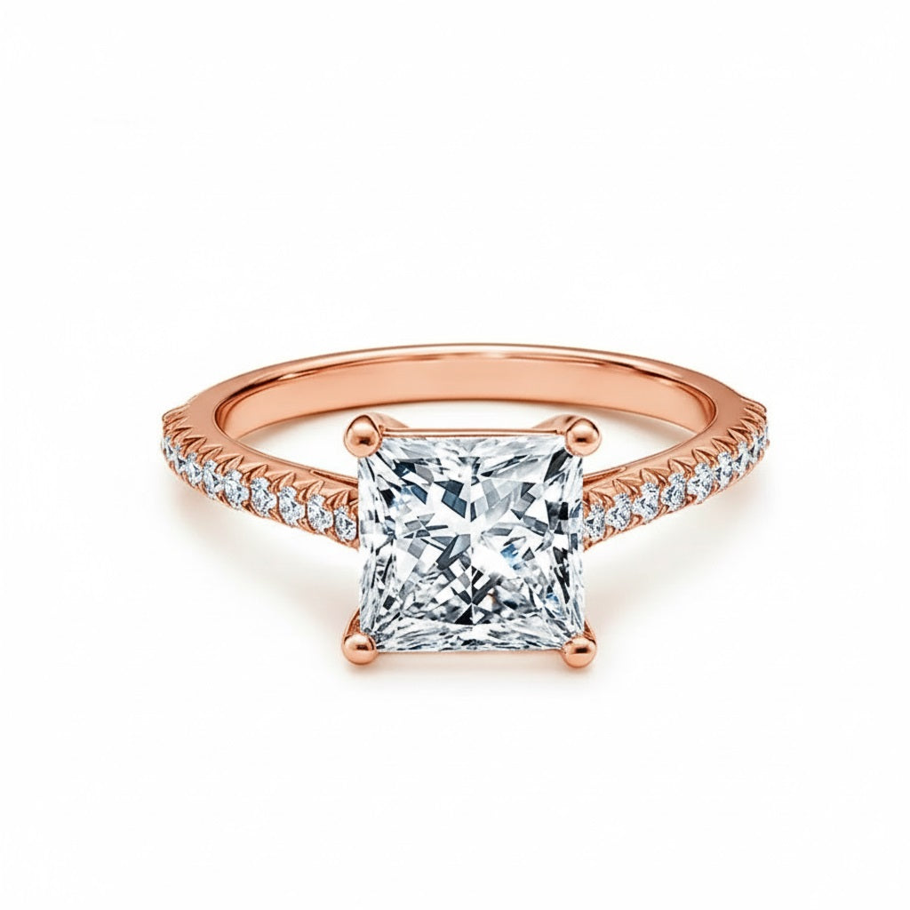 Princess cut Moissanite lab grown diamond engagement ring pave set shank with a four claw setting, on a gold band, against a white background.Moissanite engagement ring cape town south africa grand diamonds ralph jacobs jeulia 