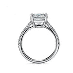 Princess cut Moissanite lab grown diamond engagement ring pave set shank with a four claw setting, on a gold band, against a white background.Moissanite engagement ring cape town south africa grand diamonds ralph jacobs jeulia 