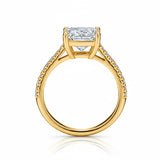 Princess cut Moissanite lab grown diamond engagement ring pave set shank with a four claw setting, on a gold band, against a white background.Moissanite engagement ring cape town south africa grand diamonds ralph jacobs jeulia 