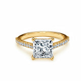 Princess cut Moissanite lab grown diamond engagement ring pave set shank with a four claw setting, on a gold band, against a white background.Moissanite engagement ring cape town south africa grand diamonds ralph jacobs jeulia 