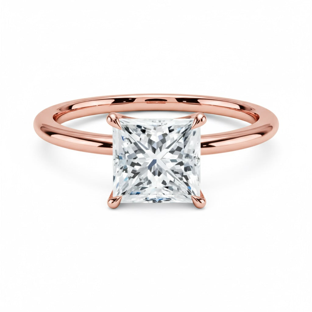 Princess cut Moissanite lab grown diamond engagement ring round shank with a four claw setting, on a gold band, against a white background.Moissanite engagement ring cape town south africa grand diamonds ralph jacobs jeulia 