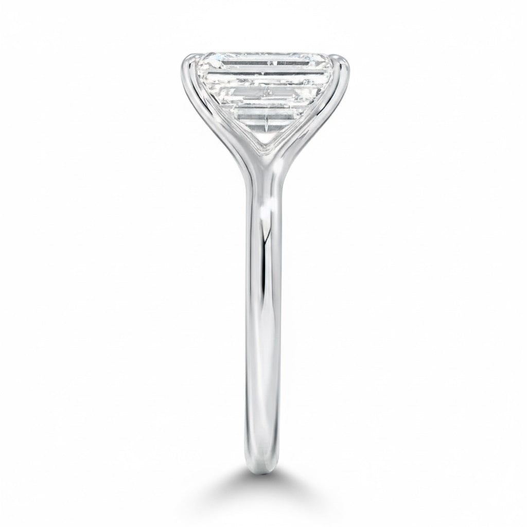 Engagement ring Radiant cut Moissanite lab grown diamond engagement ring v-Split round shank with a four cat-claw setting, on a gold band, against a white background.Moissanite engagement ring cape town south africa grand diamonds ralph jacobs jeulia 