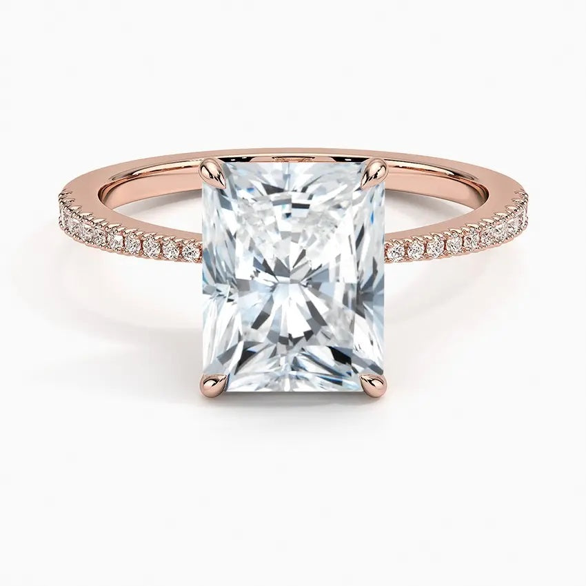 Radiant cut Moissanite lab grown diamond engagement ring pave set shank with classic four prong setting, on a gold band, against a white background.Moissanite engagement ring cape town south africa grand diamonds ralph jacobs jeulia 