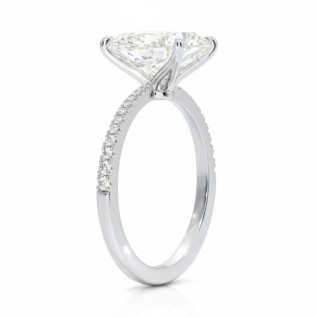 Radiant cut Moissanite lab grown diamond engagement ring pave set shank with classic four prong setting, on a gold band, against a white background.Moissanite engagement ring cape town south africa grand diamonds ralph jacobs jeulia 