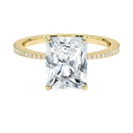 Radiant cut Moissanite lab grown diamond engagement ring pave set shank with classic four prong setting, on a gold band, against a white background.Moissanite engagement ring cape town south africa grand diamonds ralph jacobs jeulia 