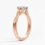 Round cut Twisted Shank Moissanite lab grown diamond engagement ring round shank with a four claw setting, on a gold band, against a white background.Moissanite engagement ring cape town south africa grand diamonds ralph jacobs jeuli