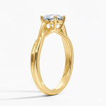 Round cut Twisted Shank Moissanite lab grown diamond engagement ring round shank with a four claw setting, on a gold band, against a white background.Moissanite engagement ring cape town south africa grand diamonds ralph jacobs jeuli