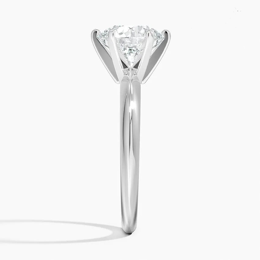 Round cut Moissanite lab grown diamond engagement ring round shank with a six claw setting, on a gold band, against a white background.Moissanite engagement ring cape town south africa grand diamonds ralph jacobs jeuli