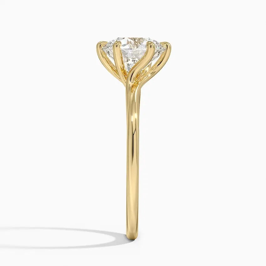 Round cut Moissanite lab grown diamond engagement ring round shank with a six claw setting, on a gold band, against a white background.Moissanite engagement ring cape town south africa grand diamonds ralph jacobs jeulia 