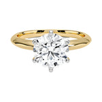 Round cut Moissanite lab grown diamond engagement ring round shank with a six claw setting, on a gold band, against a white background.Moissanite engagement ring cape town south africa grand diamonds ralph jacobs jeuli