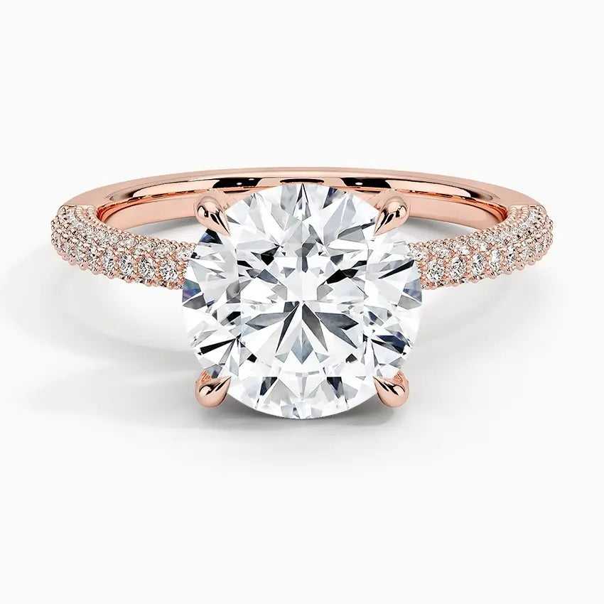 Round cut Moissanite lab grown diamond engagement ring with three row micro pave set gold shank, hidden halo and encrusted claws against a white background.Moissanite engagement ring cape town south africa grand diamonds ralph jacobs jeulia 