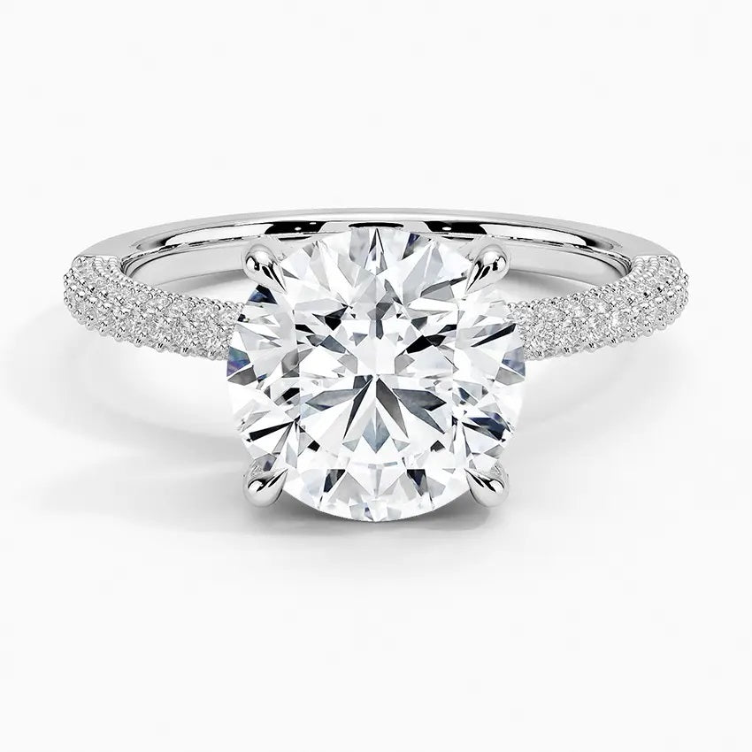 Round cut Moissanite lab grown diamond engagement ring with three row micro pave set gold shank, hidden halo and encrusted claws against a white background.Moissanite engagement ring cape town south africa grand diamonds ralph jacobs jeulia 
