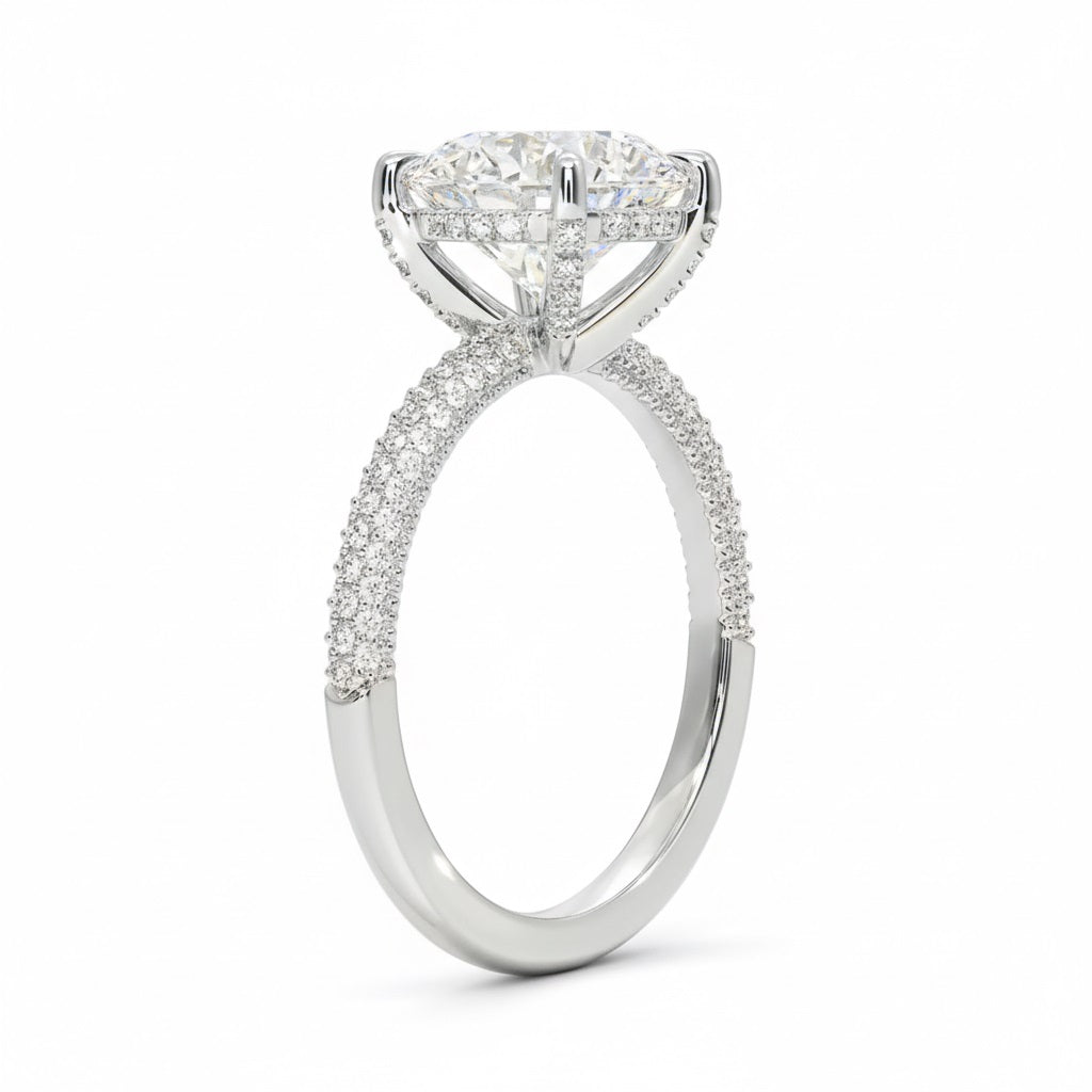 Round cut Moissanite lab grown diamond engagement ring with three row micro pave set gold shank, hidden halo and encrusted claws against a white background.Moissanite engagement ring cape town south africa grand diamonds ralph jacobs jeulia 