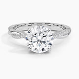 Round cut Moissanite lab grown diamond engagement ring with single side pave set twisted shank on a gold band, against a white background.Moissanite engagement ring cape town south africa grand diamonds ralph jacobs jeulia 