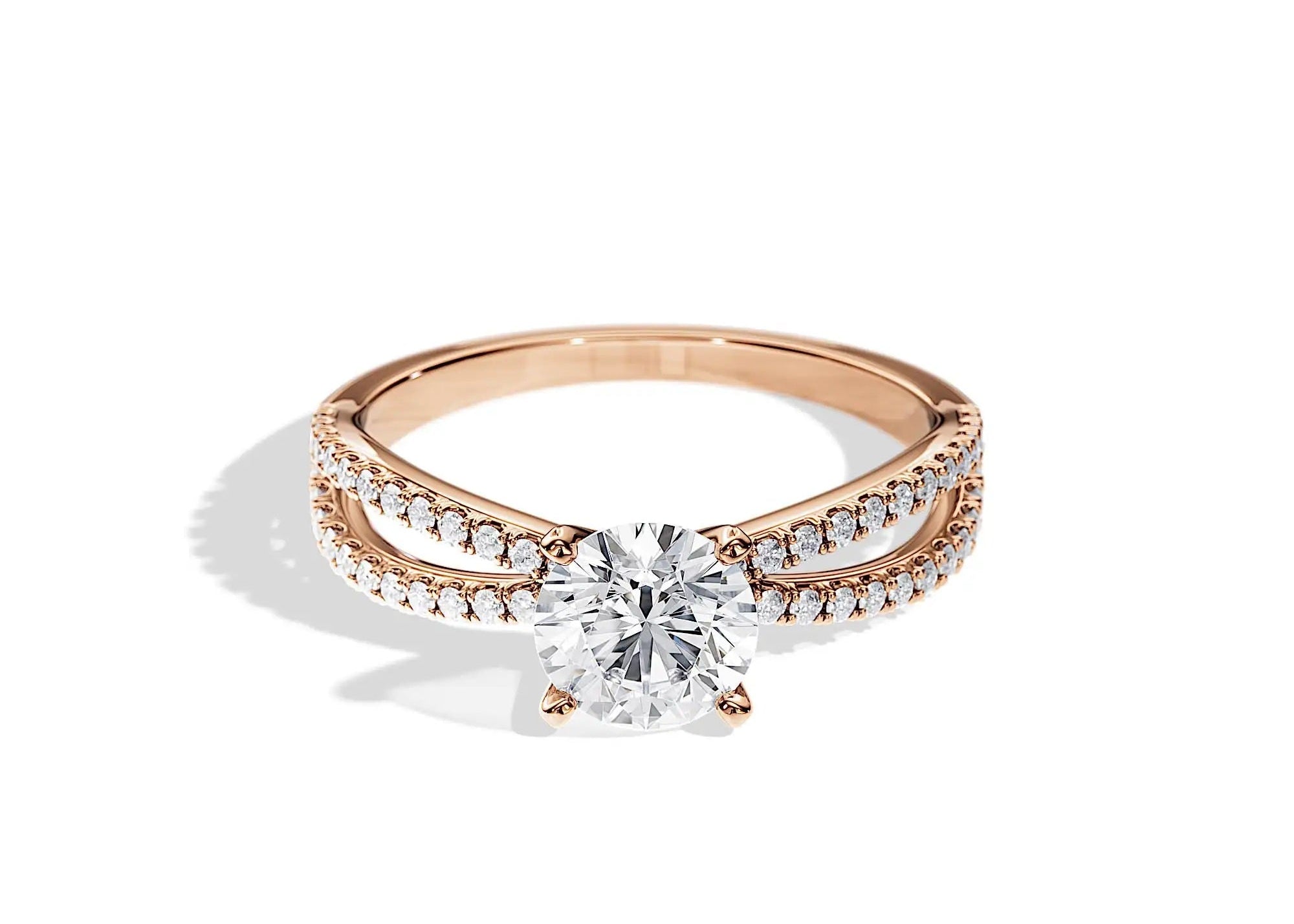 Round cut Moissanite lab grown diamond engagement ring with split pave set gold shank, against a white background.Moissanite engagement ring cape town south africa grand diamonds ralph jacobs jeulia 