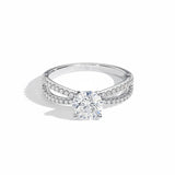 Round cut Moissanite lab grown diamond engagement ring with split pave set gold shank, against a white background.Moissanite engagement ring cape town south africa grand diamonds ralph jacobs jeulia 