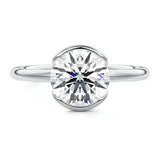 Engagement ring Round cut Moissanite lab grown diamond engagement ring  with open tube setting, on a gold band, against a white background.Moissanite engagement ring cape town south africa grand diamonds ralph jacobs jeulia 