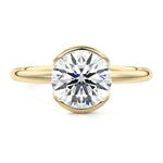 Engagement ring Round cut Moissanite lab grown diamond engagement ring  with open tube setting, on a gold band, against a white background.Moissanite engagement ring cape town south africa grand diamonds ralph jacobs jeulia 