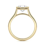 Round cut Moissanite lab grown diamond engagement ring round shank with a bezel setting, on a gold band, against a white background.Moissanite engagement ring cape town south africa grand diamonds ralph jacobs jeulia 